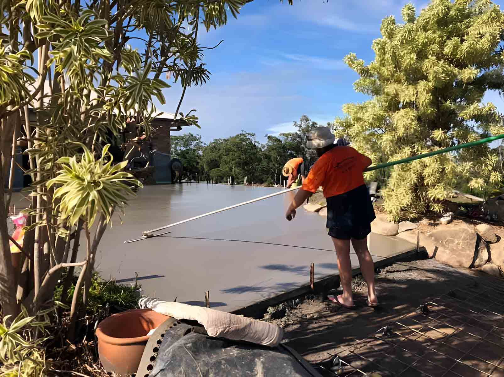 A Man Is Standing On A Concrete Surface With A Hose — A2Z Property Services In Cooroy, QLD