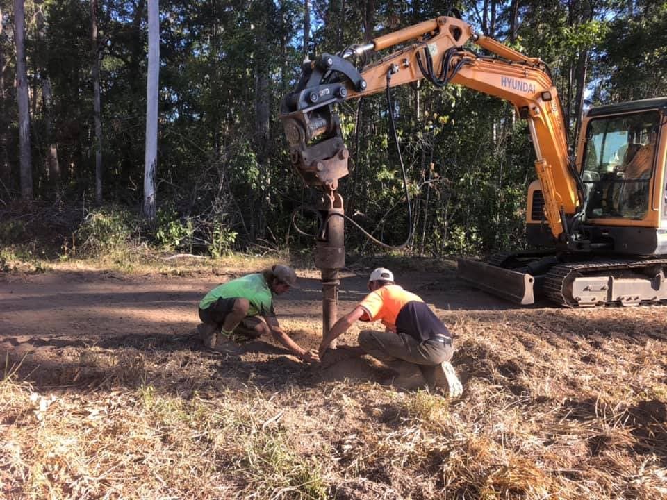 A Man Is Standing On A Concrete Surface With A Hose — A2Z Property Services In Cooroy, QLD