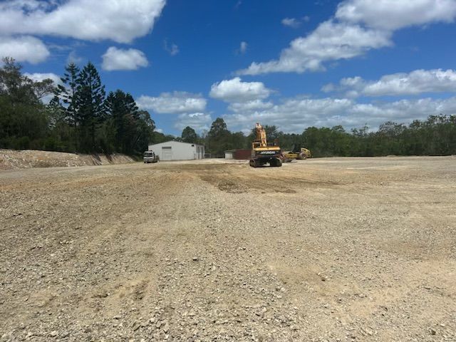 A Large Dirt Field With A Lot Of Trees In The Background — A2Z Property Services In Kybong, QLD