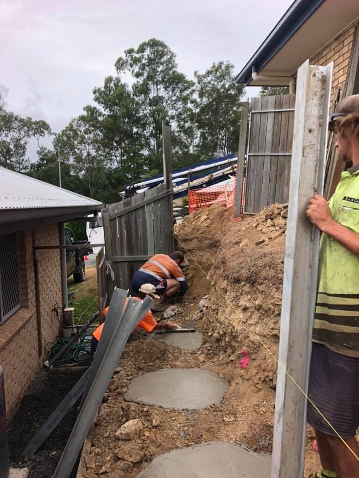 A Workers Installing Stepping Stones Along a Dirt Path — A2Z Property Services In Cooroy, QLD