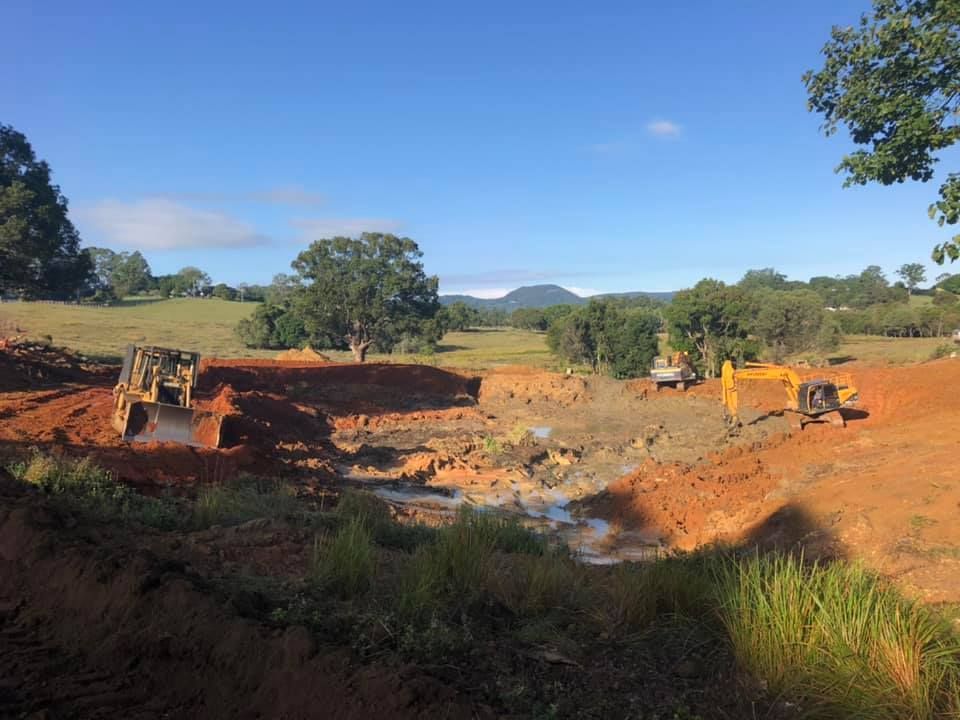 A Construction Site with Heavy Machinery Excavating Earth — A2Z Property Services In Cooroy, QLD