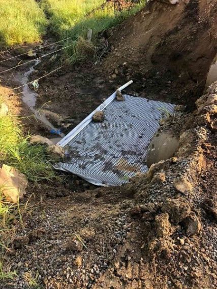 A Piece Of Metal Is Laying In The Dirt Next To A Stream — A2Z Property Services In Widgee, QLD
