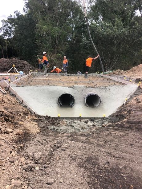 A Group Of People Are Working On A Bridge In The Dirt — A2Z Property Services In Kybong, QLD
