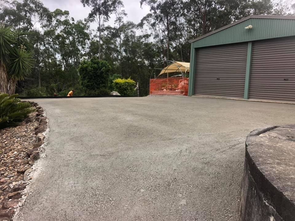 A Driveway Leading to A Green Shed with Two Garage Doors — A2Z Property Services In Cooroy, QLD