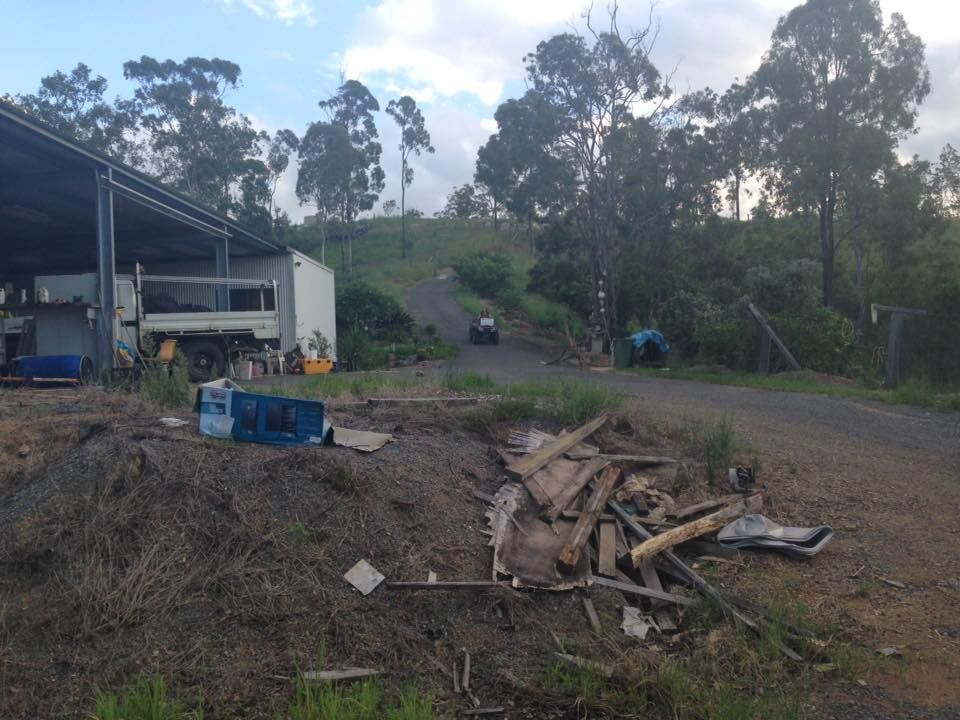A Gravel Road Leads to A Building — A2Z Property Services In Cooroy, QLD