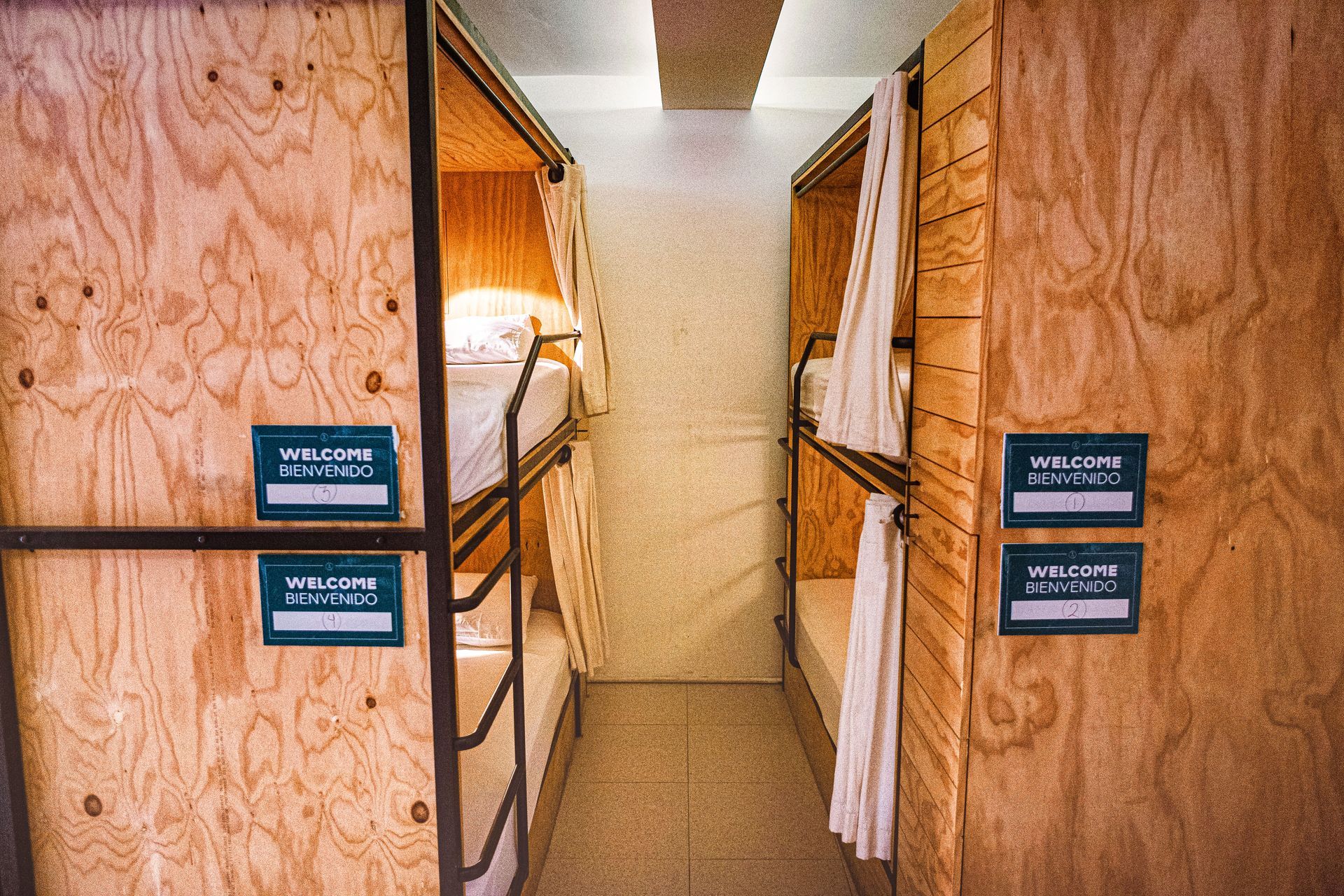 A row of bunk beds in a room with wooden walls.
