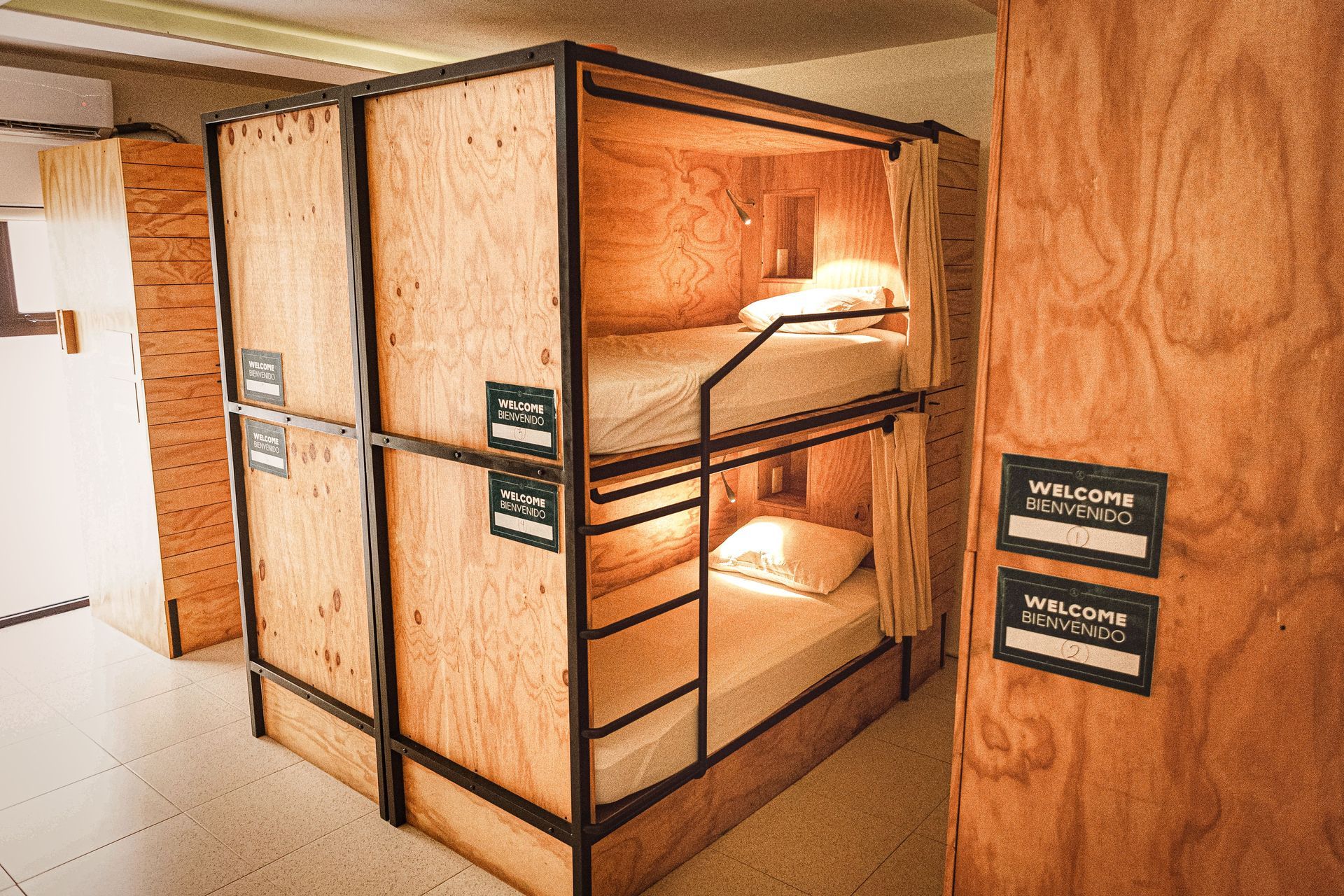 A bunk bed made of wood and metal in a room.