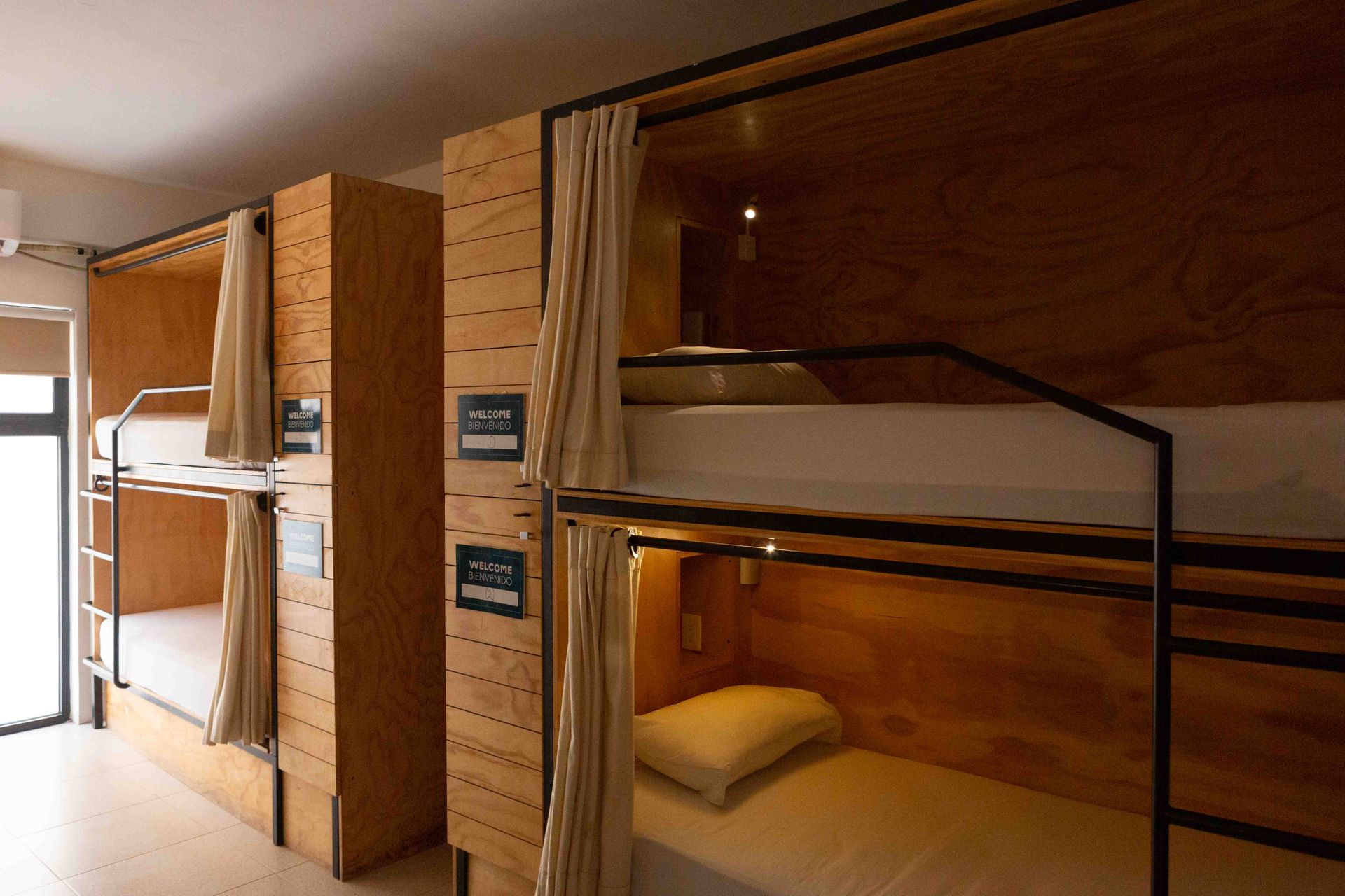 A row of bunk beds in a room with wooden walls.