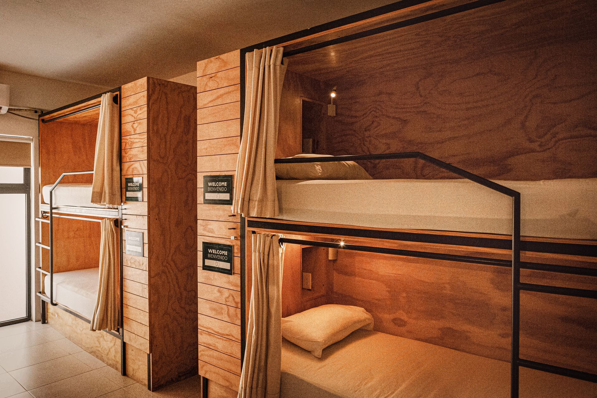A row of bunk beds in a room with wooden walls.