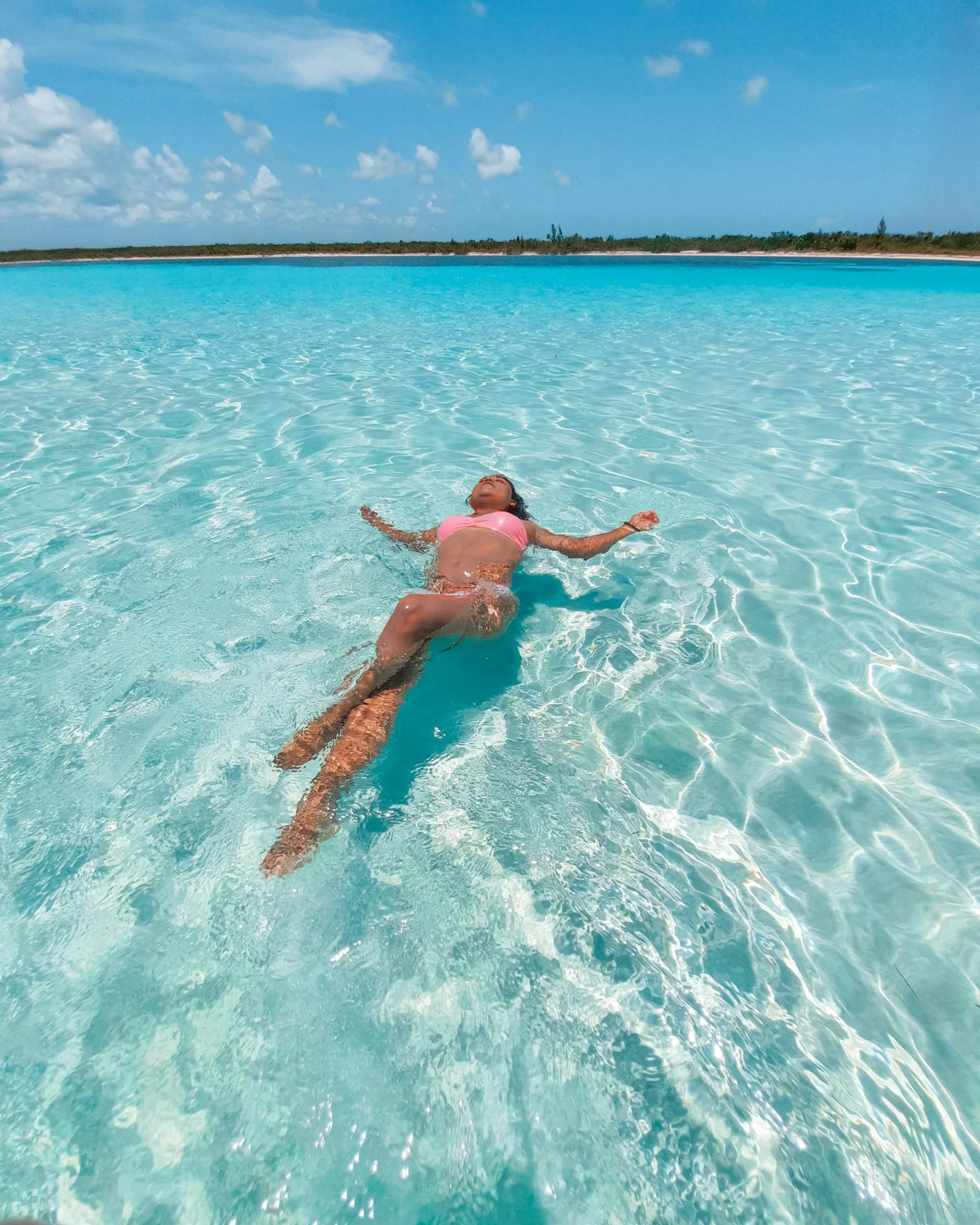 A scuba diver is swimming in the ocean near a coral reef.
