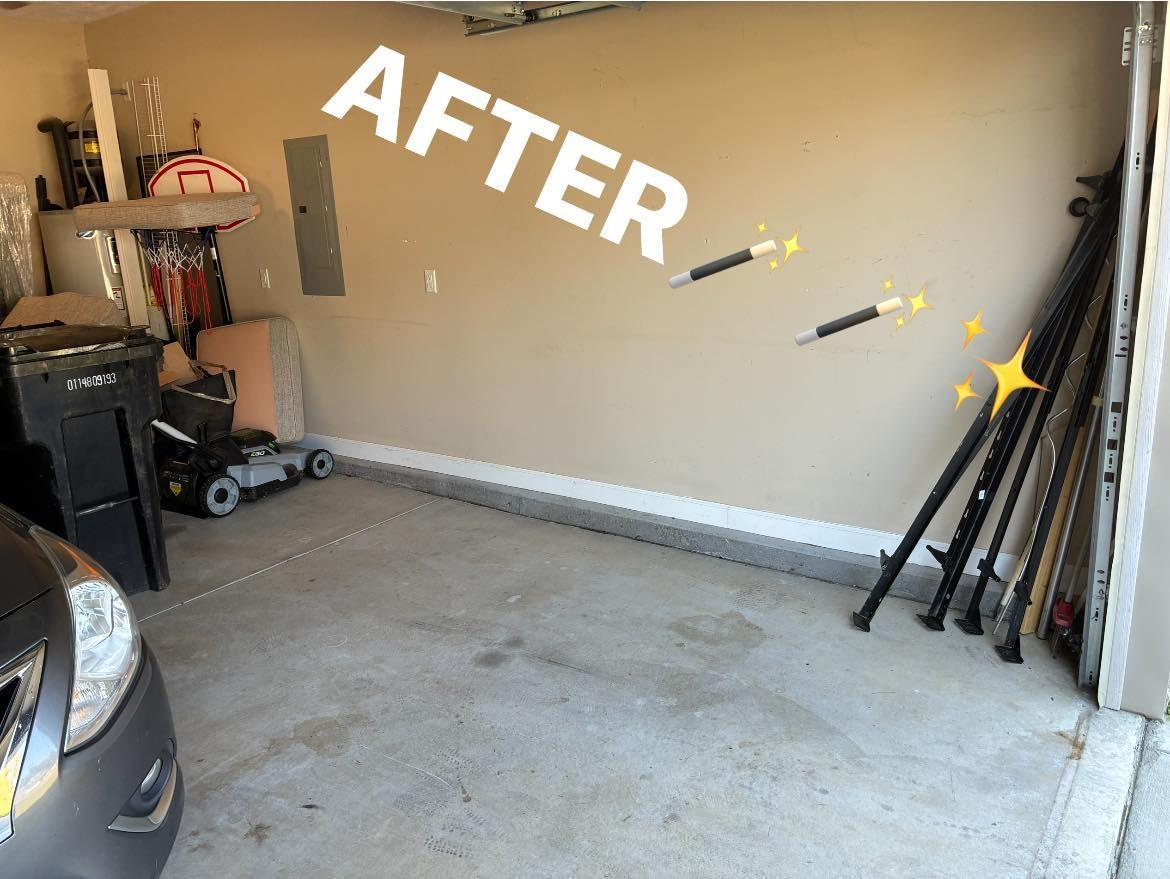 A cleaned garage with items organized along the walls and a partially visible car in the foreground.