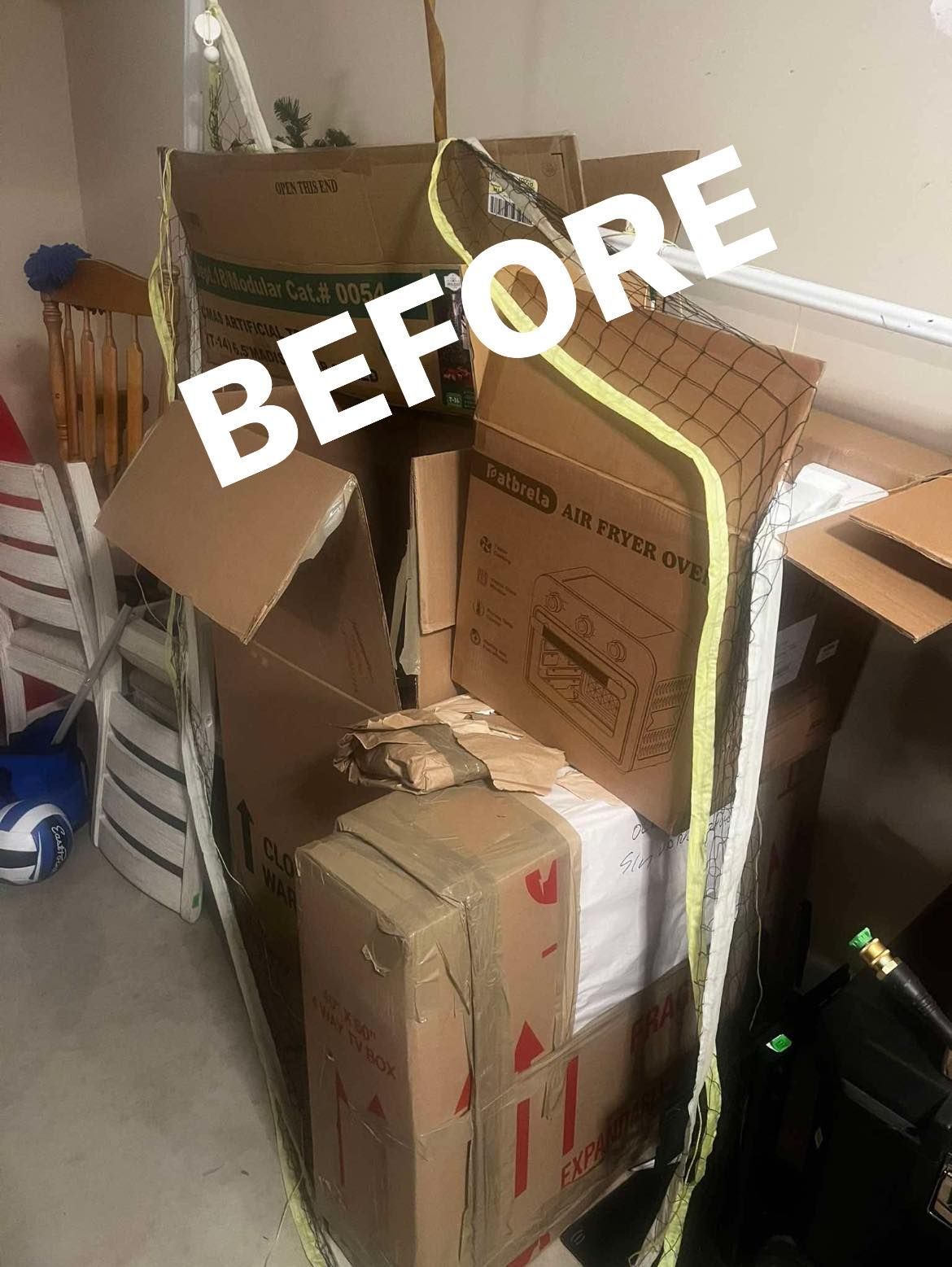 A large, disorganized stack of cardboard boxes and packing materials in a room with the word 