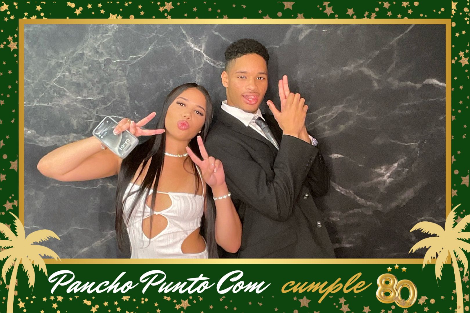 A man and a woman are posing for a picture in a photo booth.