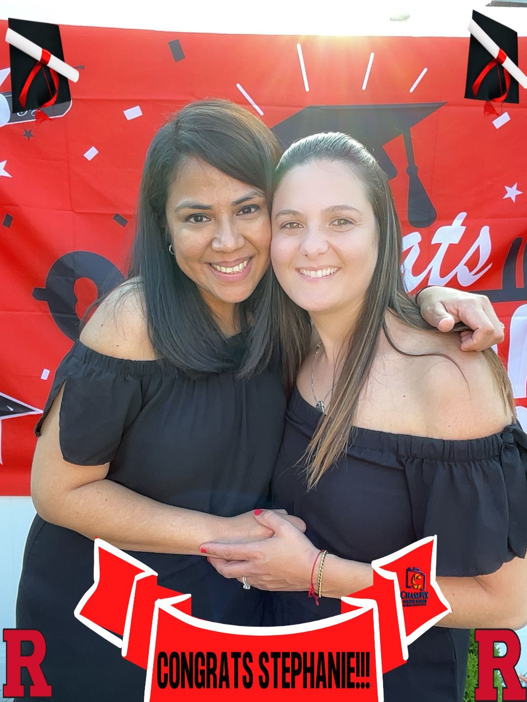 Two women are posing for a picture with a banner that says congrats stephanie