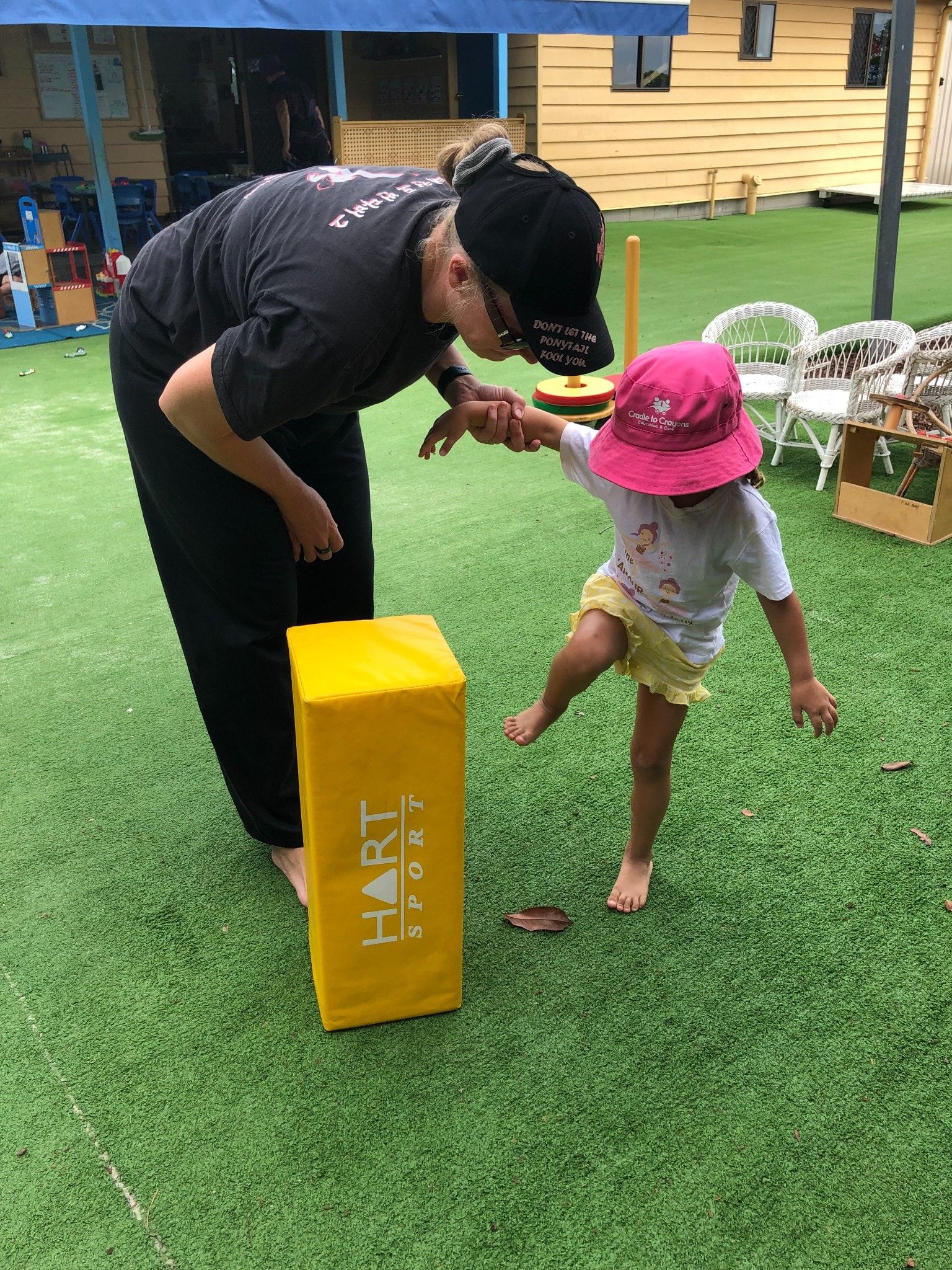 A Little Boy Is Sitting At A Table Playing With Green Paint – Bundaberg North, QLD - Cradle to Crayons Education & Care