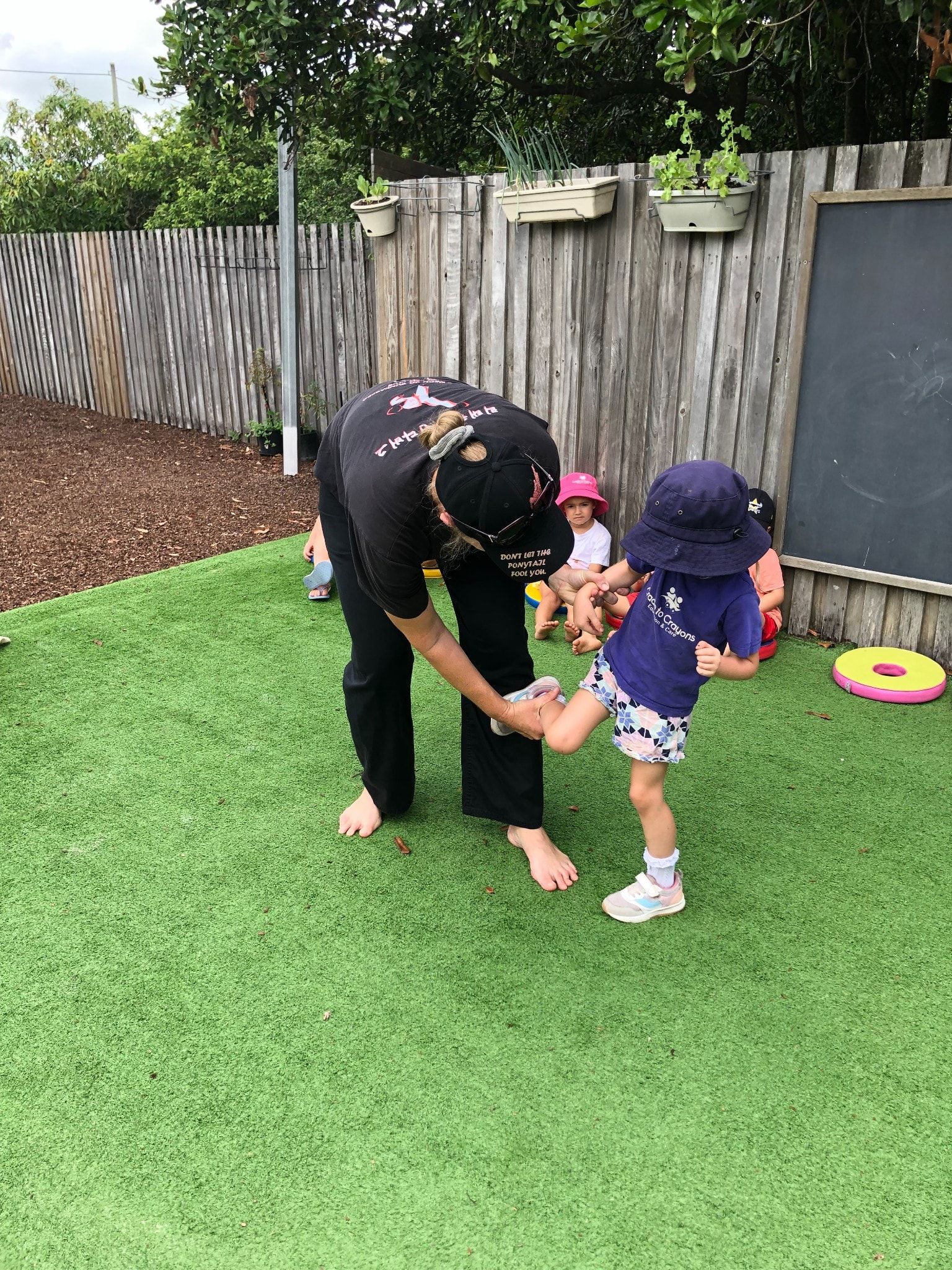 A Little Boy Is Kicking A Soccer Ball In The Grass – Bundaberg North, QLD - Cradle to Crayons Education & Care