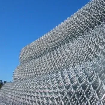 A metal gate connected to a blue building wall on a concrete walkway outdoors.