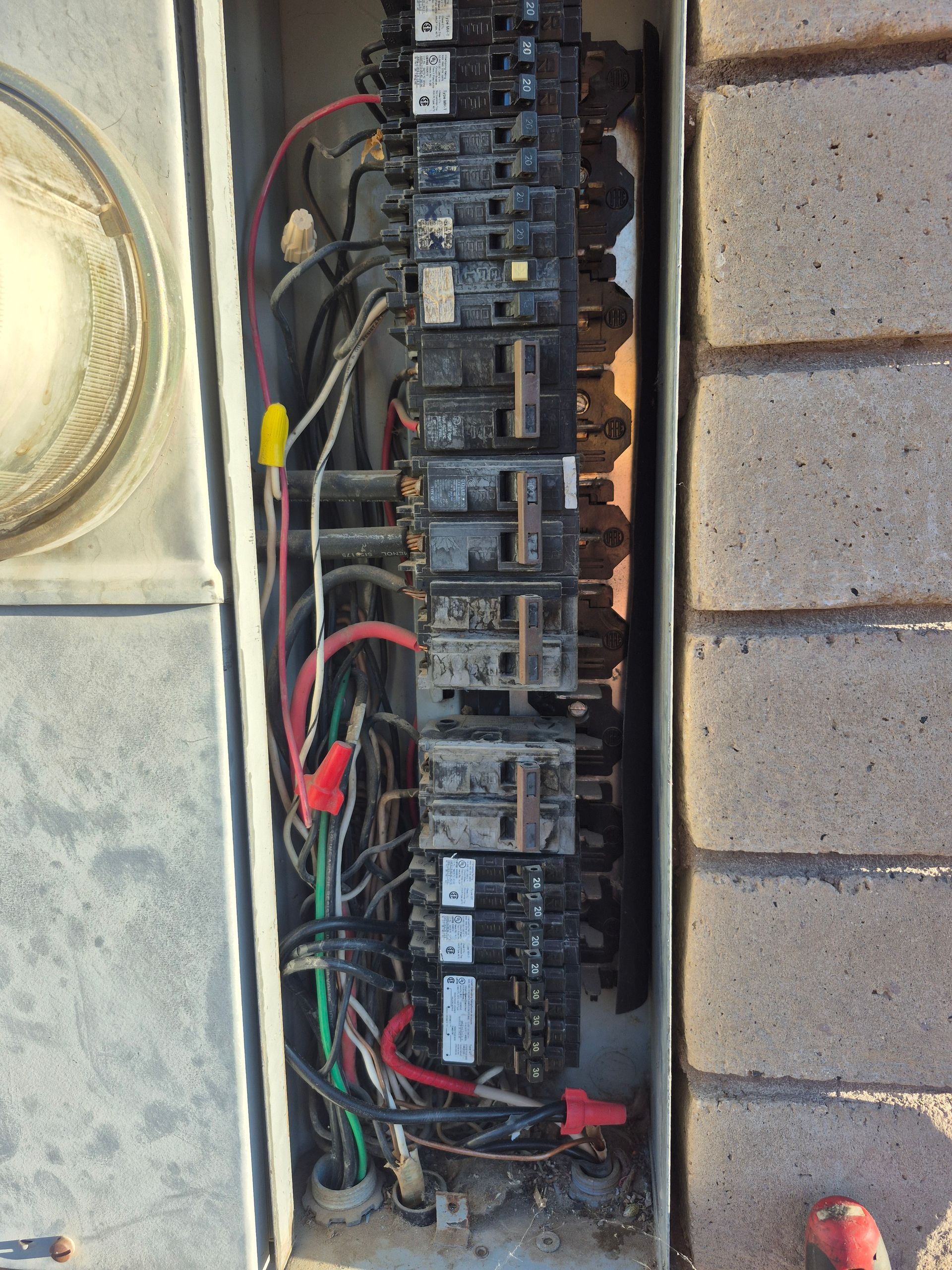 Electrical panel with circuit breakers and wiring.
