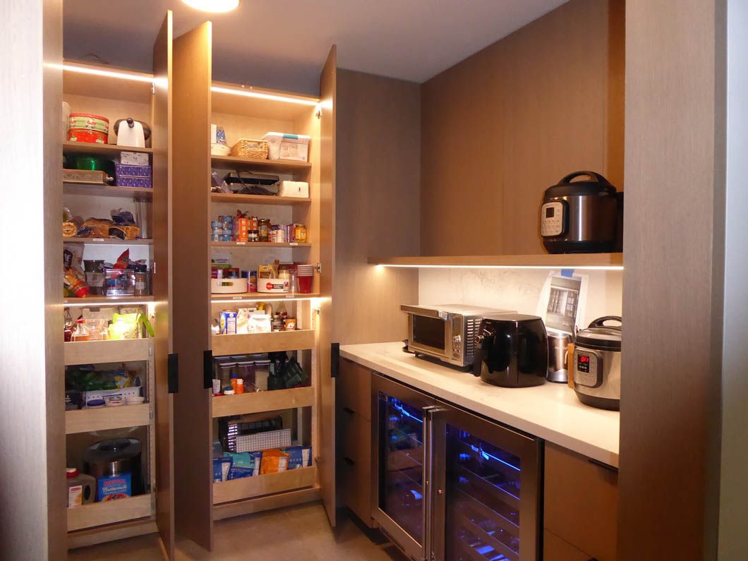 A kitchen with a pantry filled with food and appliances