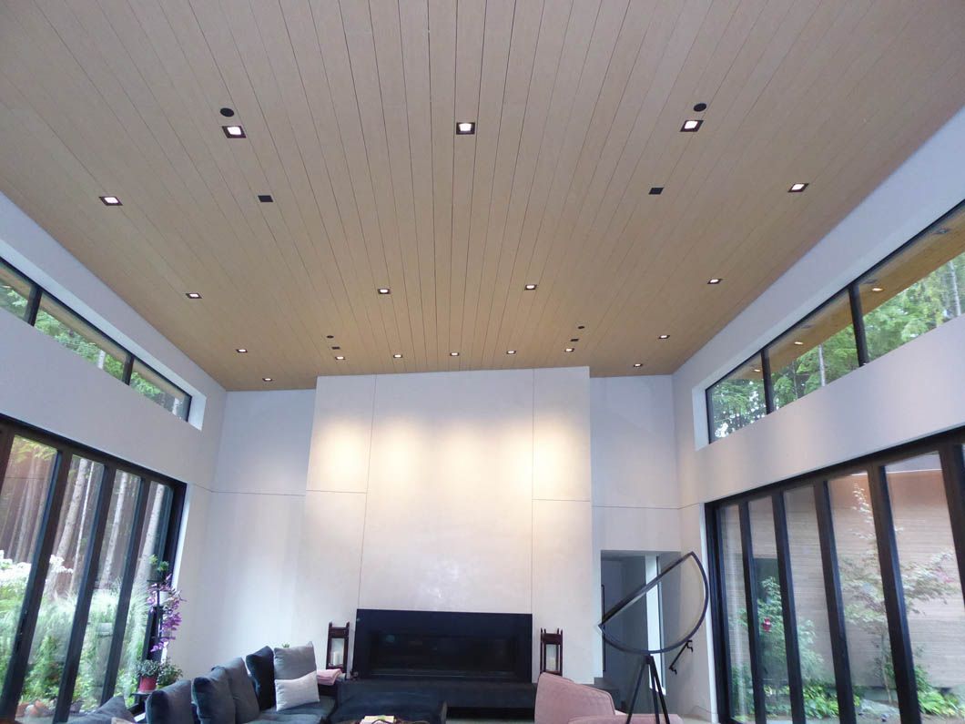 A living room with lots of windows and a couch