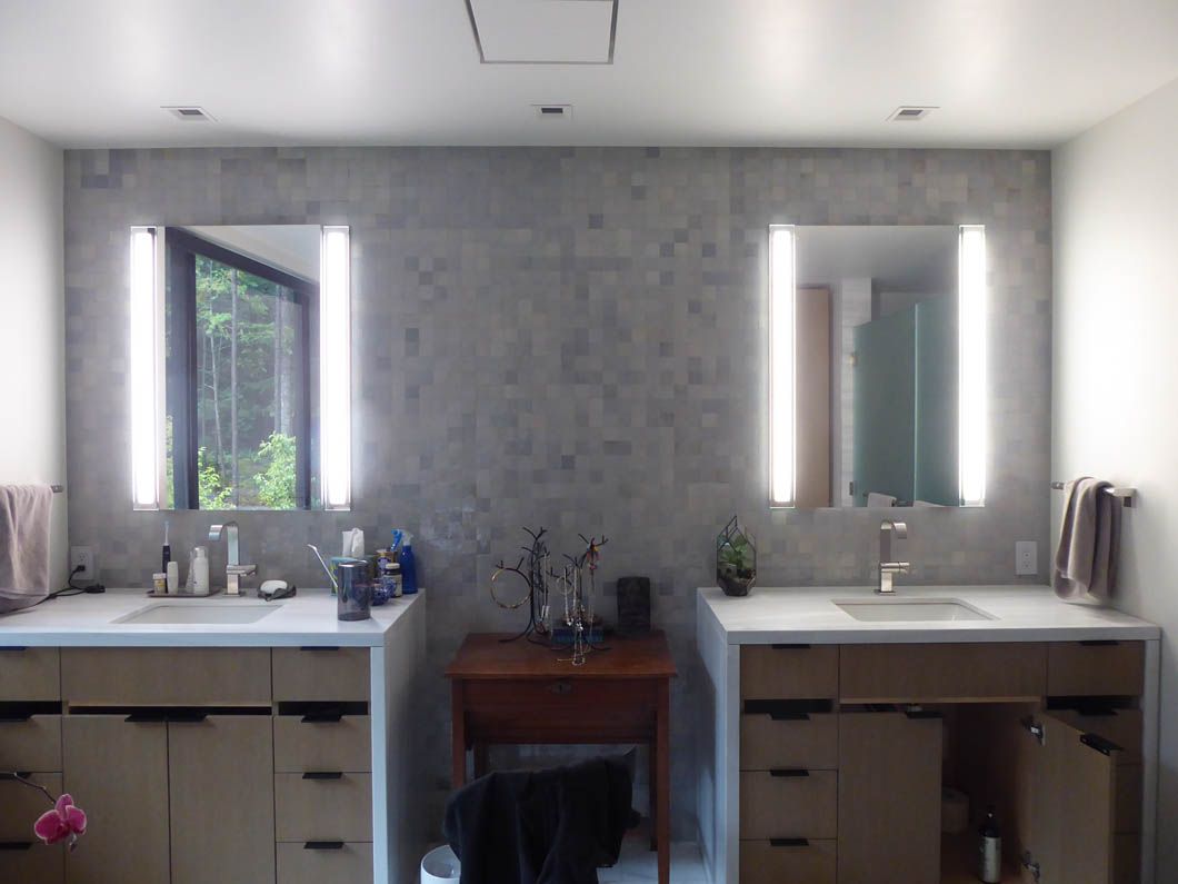 A bathroom with two sinks and two mirrors.