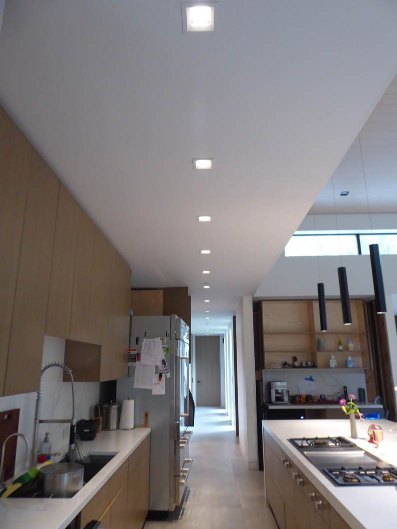 A kitchen with a stove top oven and a refrigerator