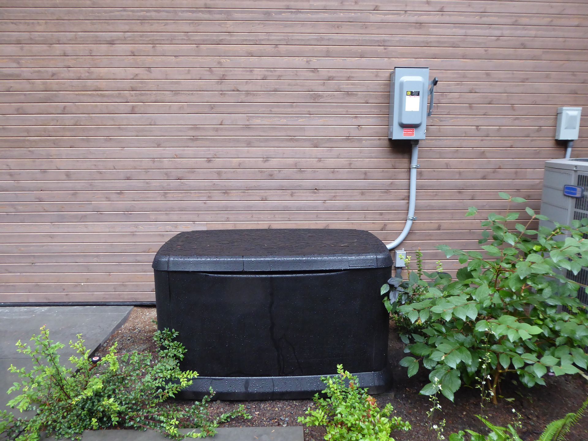 A black box is attached to the side of a building