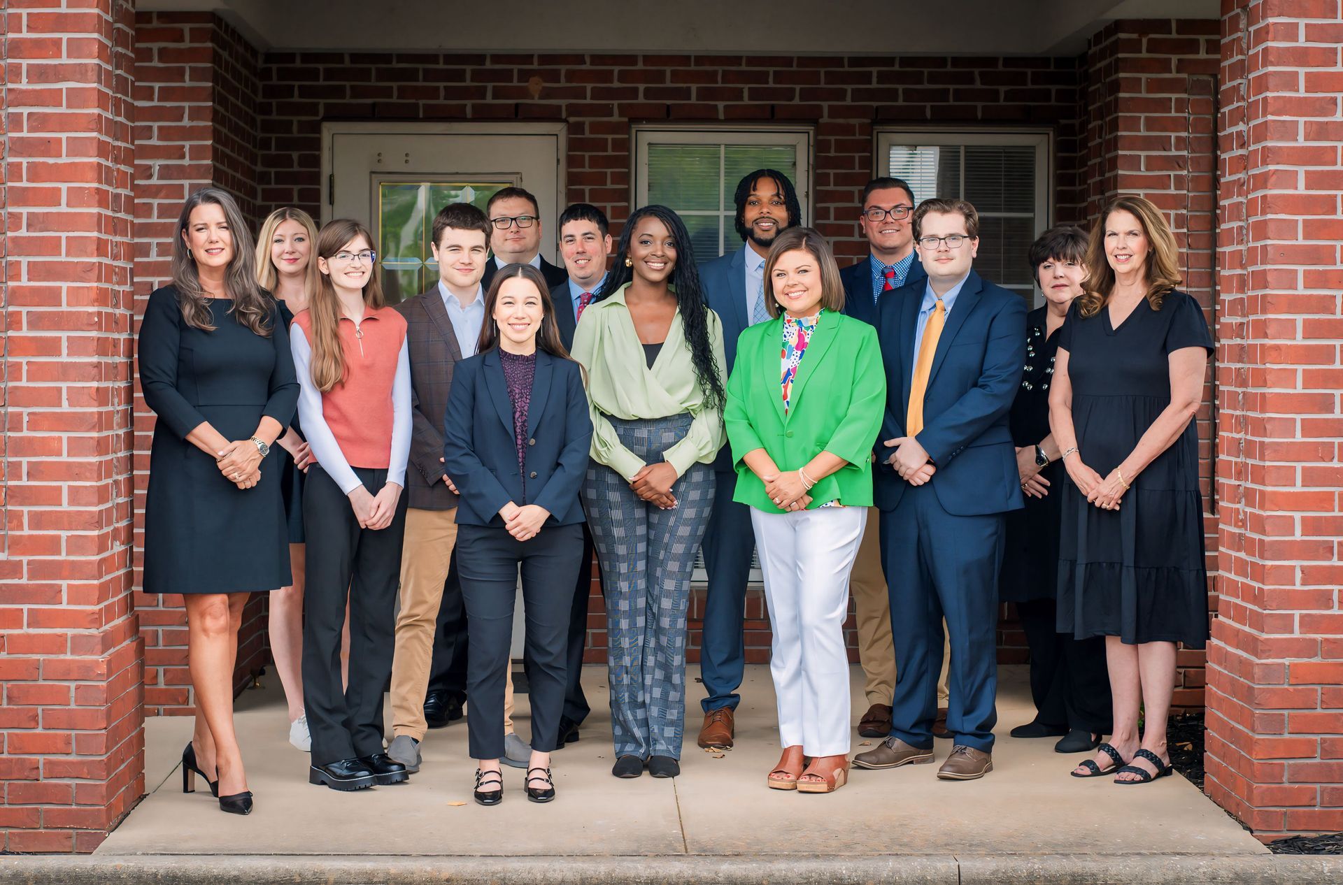 A group of people are posing for a picture in front of a brick building. — Florence, AL — Patterson, Prince & Associates, PC A group of people are posing for a picture in front of a brick building. — Florence, AL — Patterson, Prince & Associates, PC