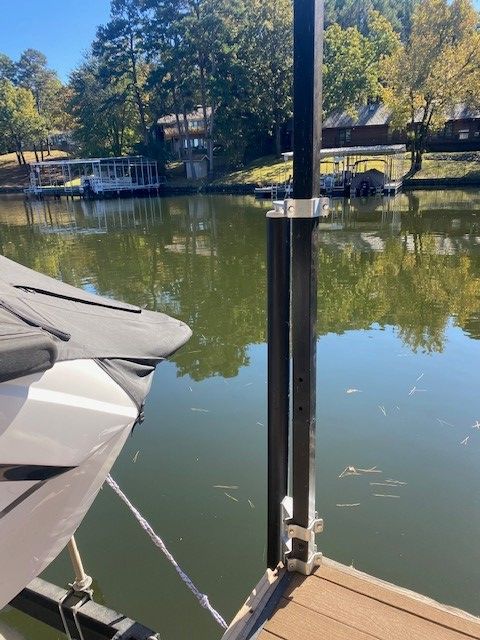 A boat is sitting on a dock next to a body of water