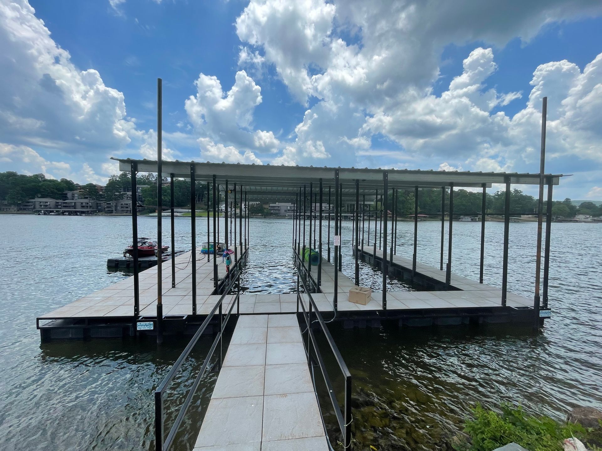 A dock on a lake with a boat in the water