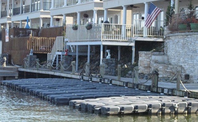 A dock with a large house in the background