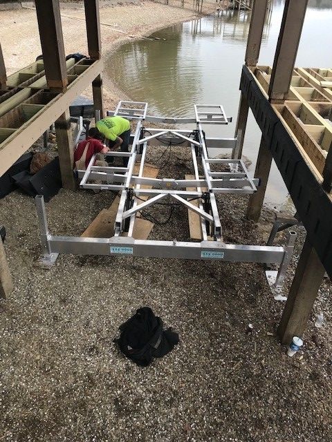 A boat lift is being built on the shore of a lake