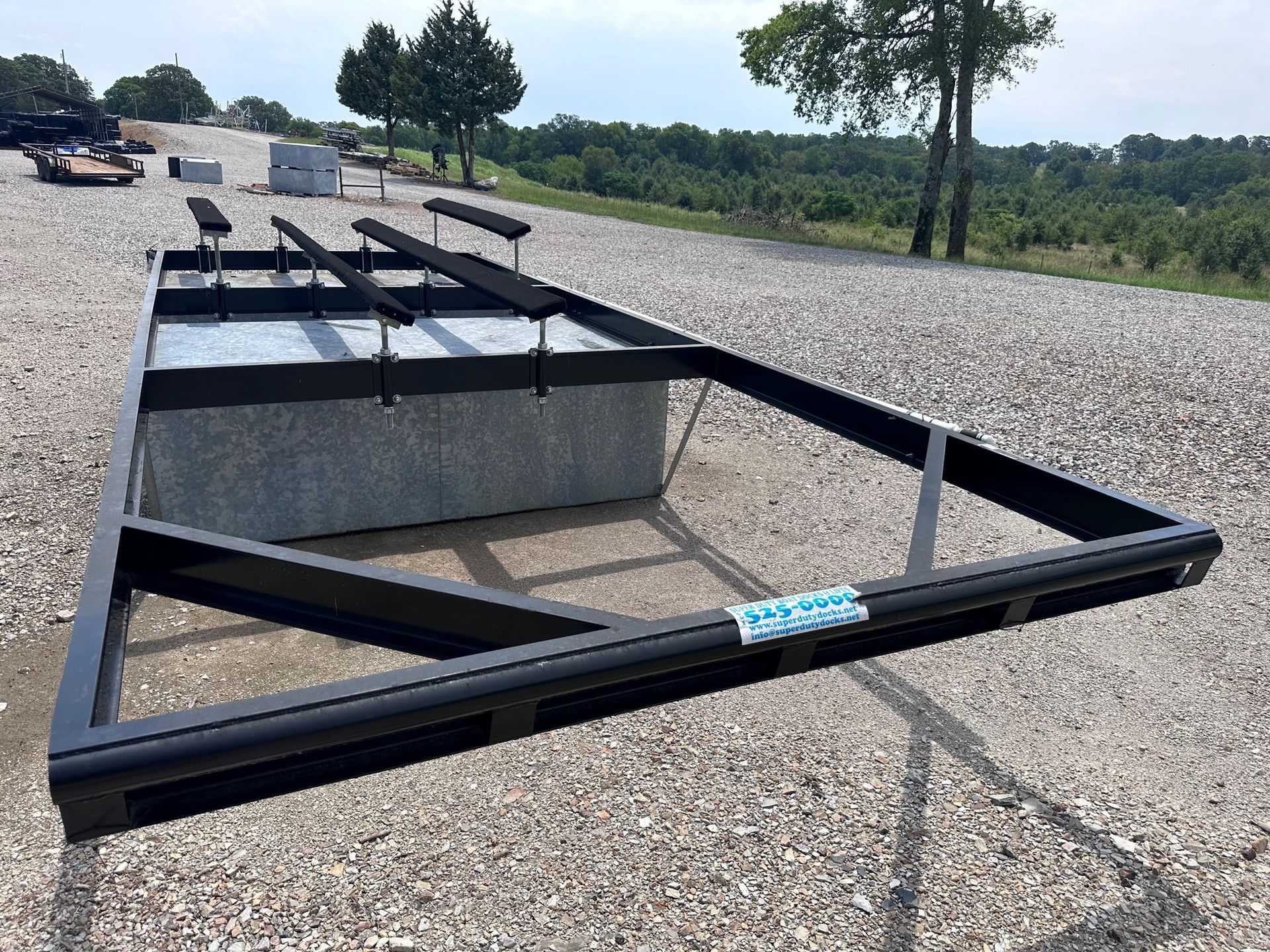 A metal frame is sitting on a gravel road