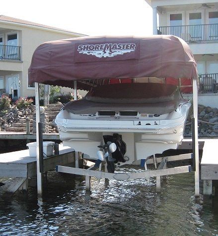 A boat on a lift with the word shoremaster on it