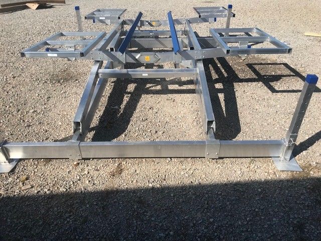 A metal structure is sitting on a gravel road