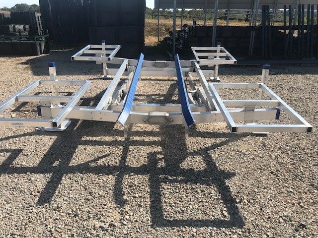 A metal frame is sitting on a gravel road
