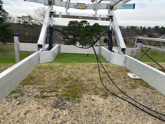 A ladder is sitting on top of a grassy field