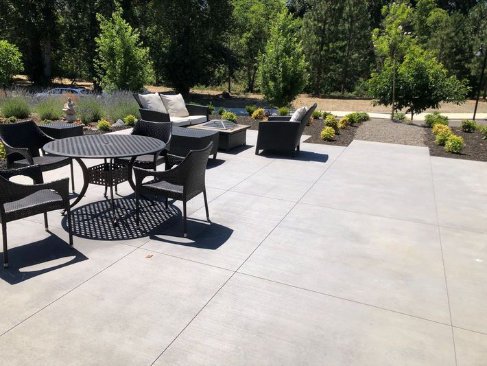 New concrete walkway with steps and planter boxes in front of a house in Ashland, Oregon.