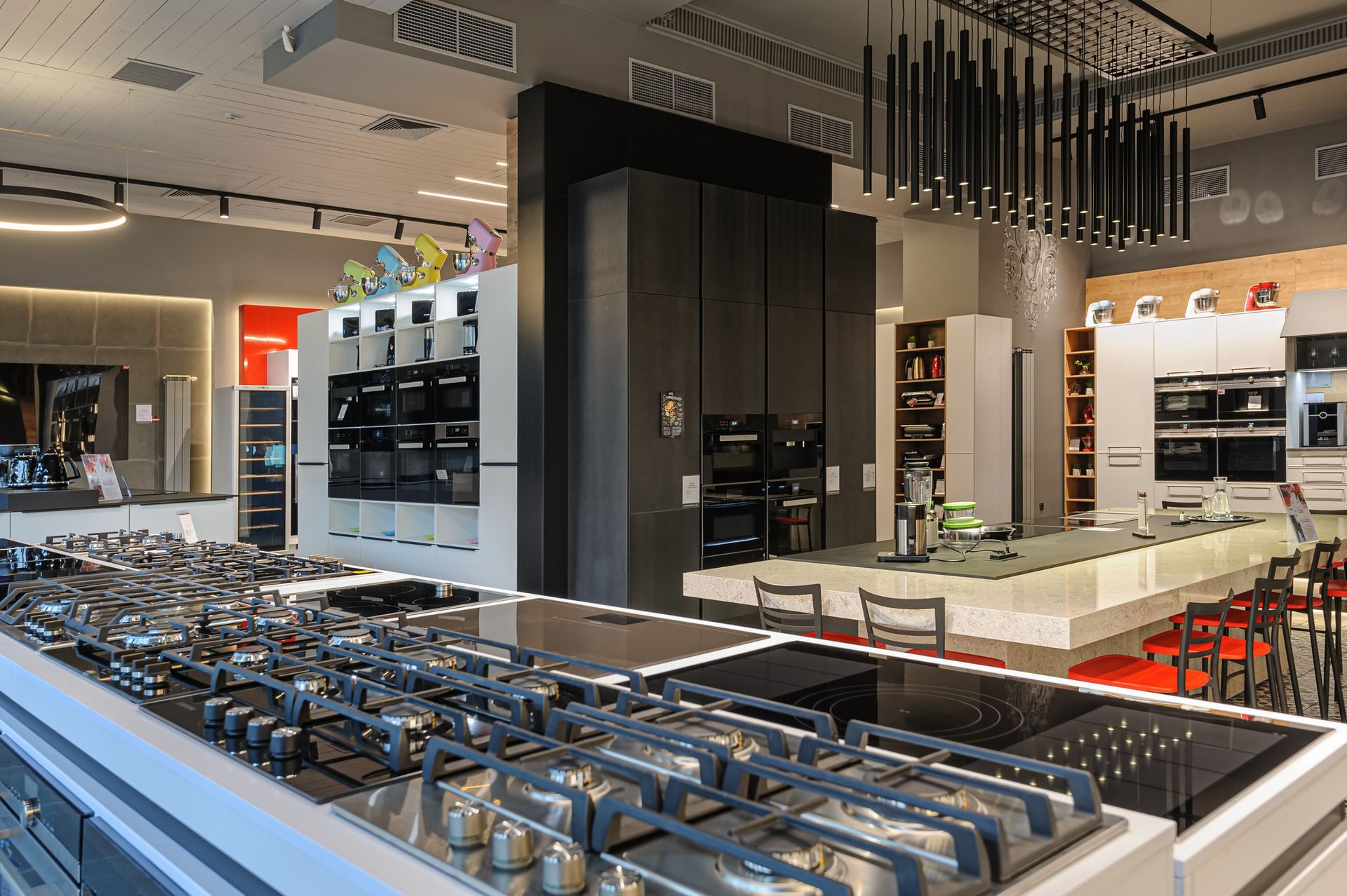 A kitchen with a lot of pots and pans on the stove.