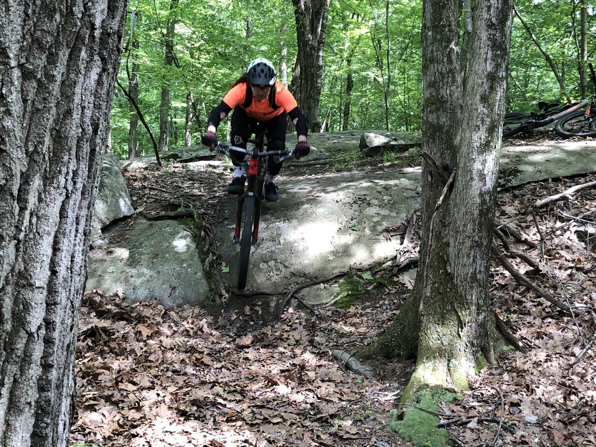 woman in rock garden on mountain bike trail