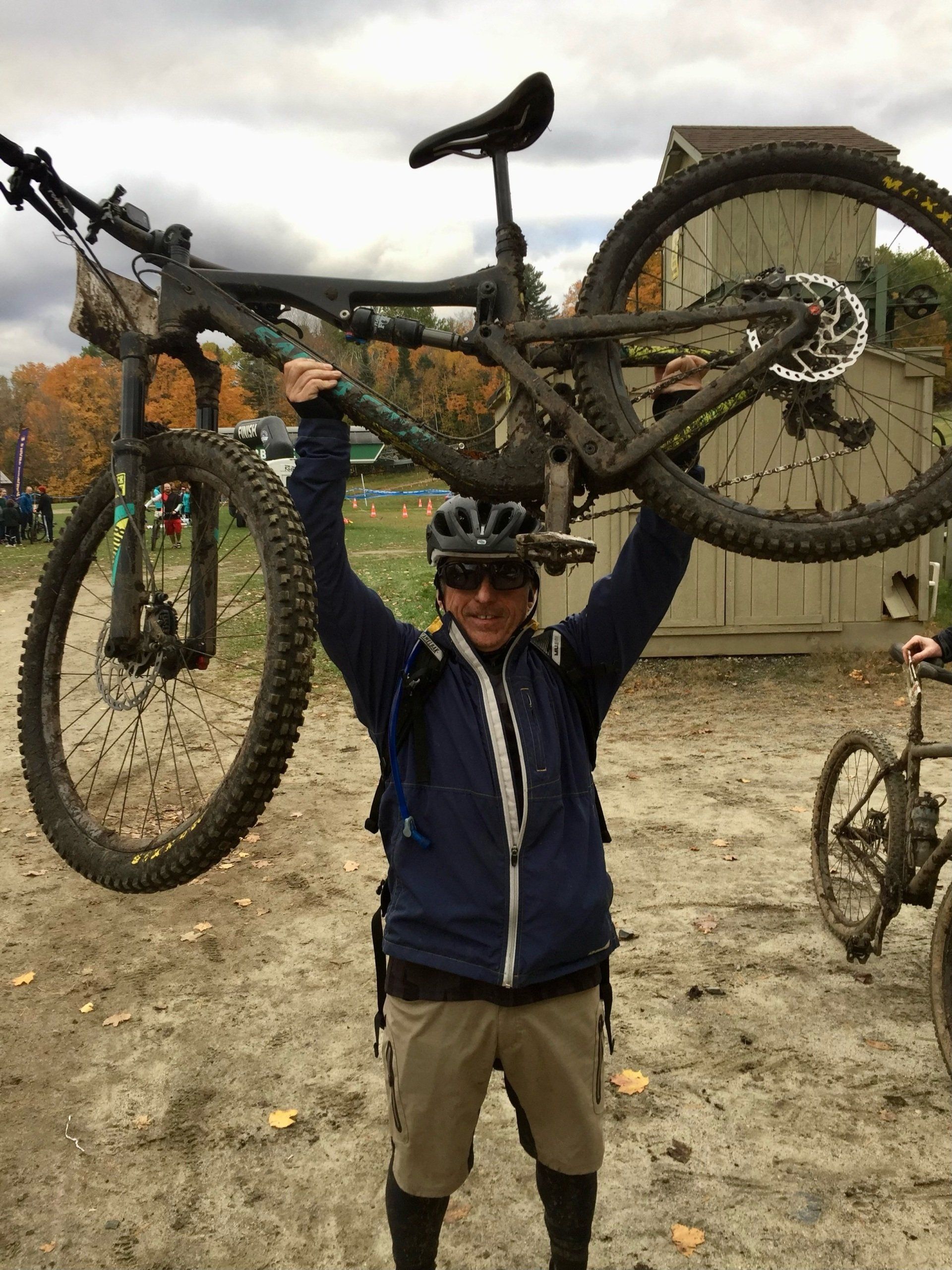 man showing off mountain bike over his head