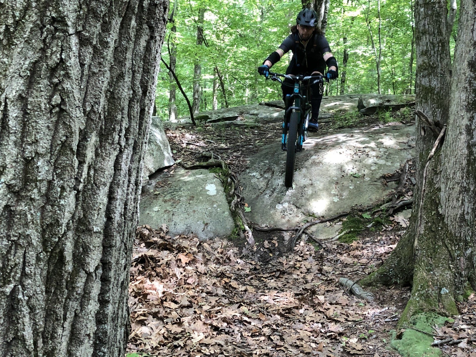 woman in rock garden on mountain bike trail
