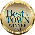 A gold badge that says best in town winner 2023