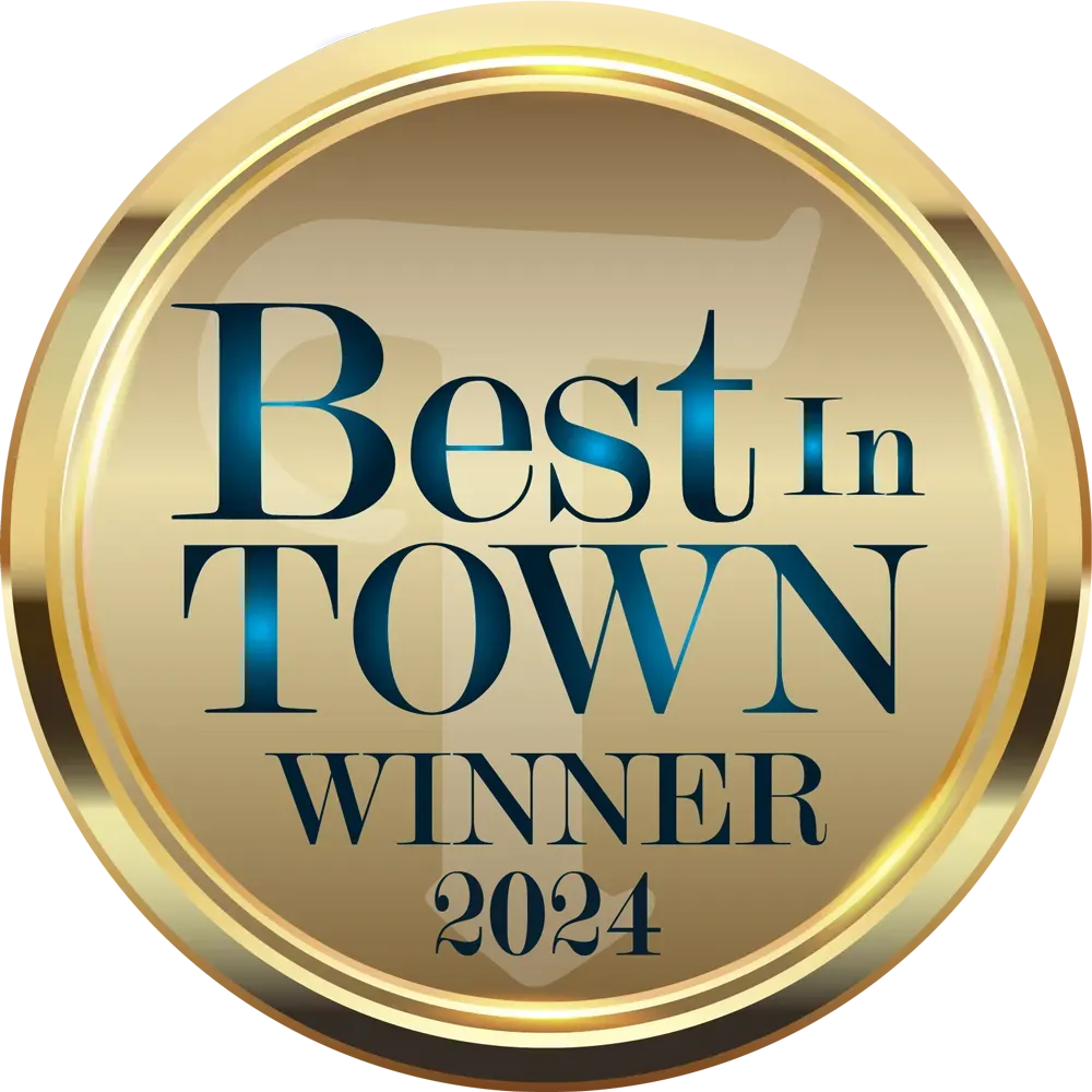 A gold badge that says best in town winner 2023
