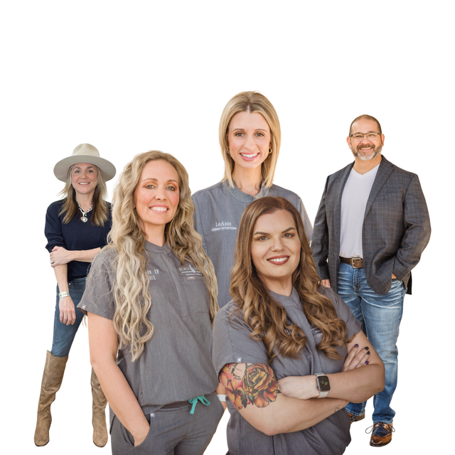 Two women in purple scrubs are posing for a picture.