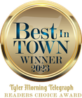 A gold badge that says best in town winner 2023