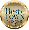 A gold badge that says best in town winner 2023