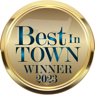 A gold badge that says best in town winner 2023