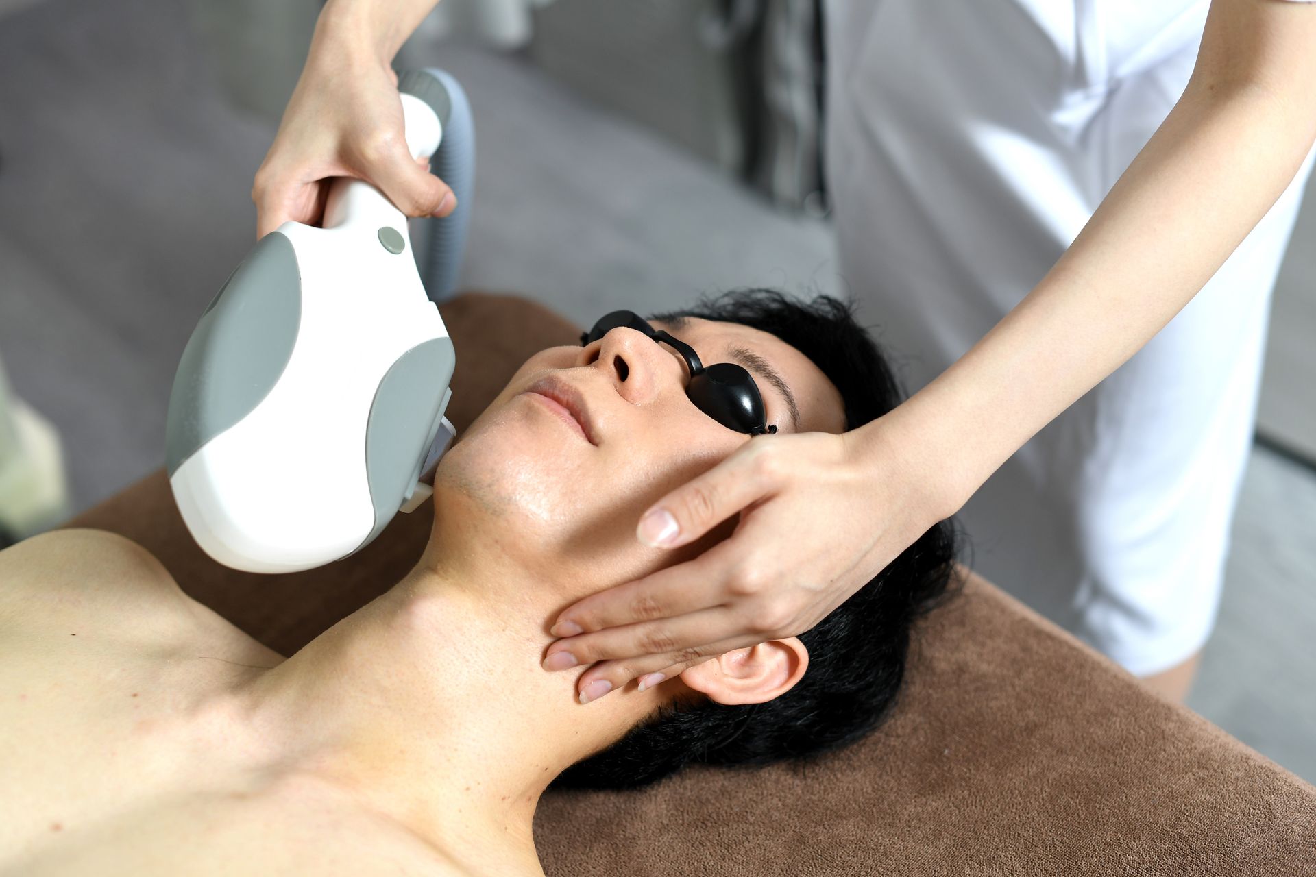 A woman is getting a facial treatment at a beauty salon.