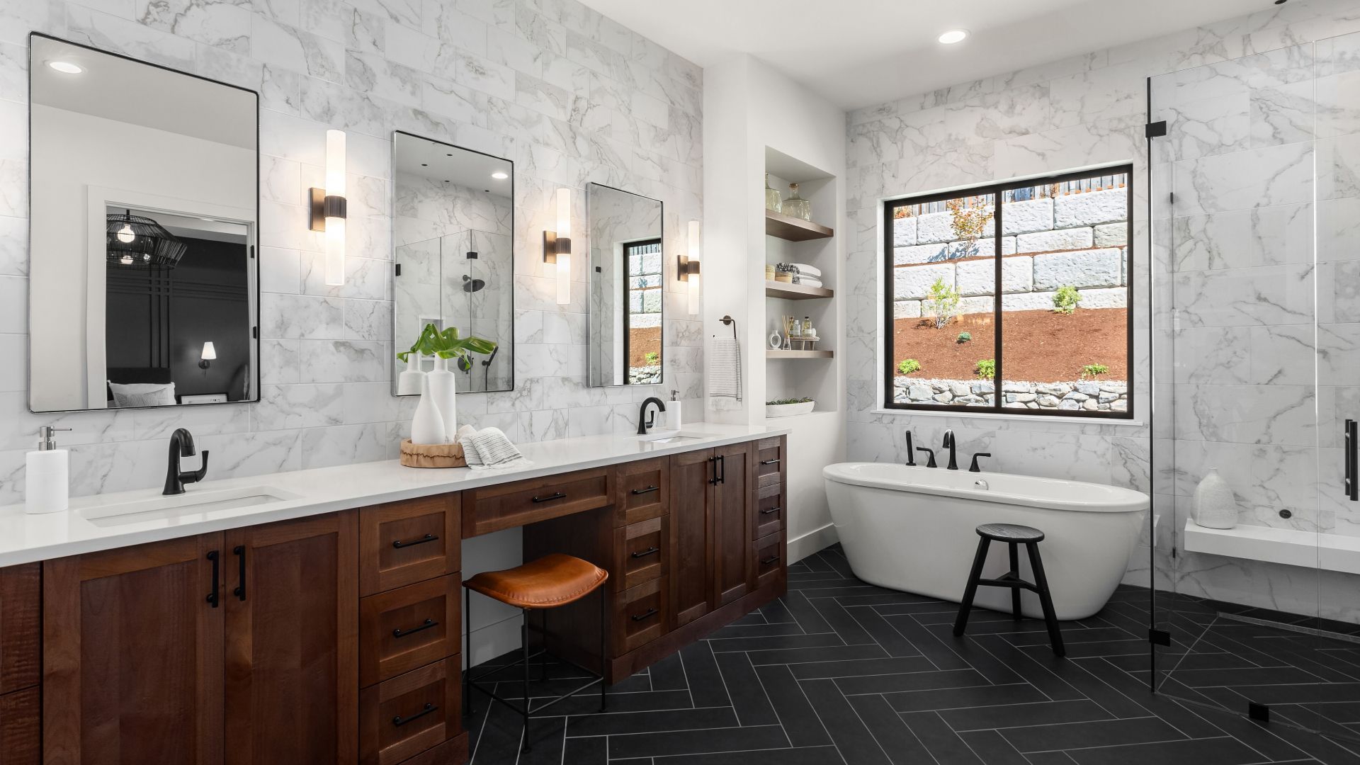 A bathroom with a bathtub , sinks , mirrors and a walk in shower.